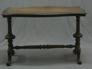A Victorian rosewood stretcher table of serpentine outline, raised on turned supports united by an H framed stretcher 41"
