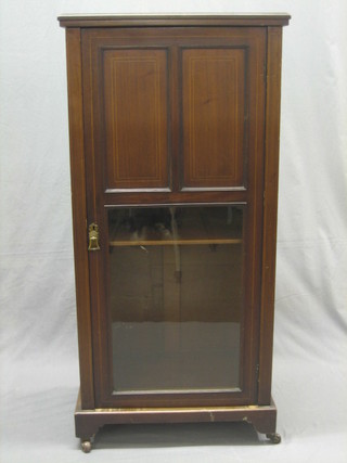 An inlaid mahogany music cabinet enclosed by a glazed panelled door 22"