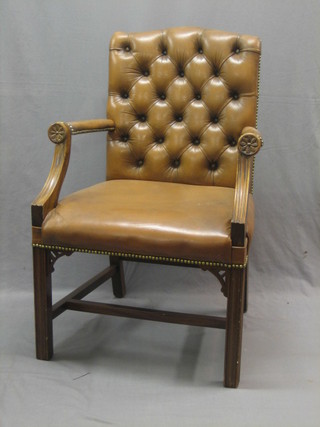 A 19th/20th Century Georgian style mahogany framed library chair upholstered in brown buttoned leather