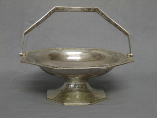 An octagonal pierced silver cake basket raised on an octagonal spreading foot, London 1914, 14 ozs, inscribed