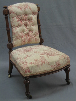 An Edwardian walnut nursing chair with fluted columns, raised on turned and fluted supports