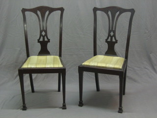 A set of 4 19th Century Chippendale style mahogany dining chairs with upholstered drop in seats, raised on square tapering supports