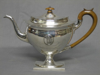 A Georgian style oval silver teapot raised on a square foot, London 1911, 15 ozs      