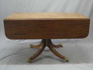 A 19th Century mahogany pedestal Pembroke table fitted a frieze drawer and raised on a turned column and tripod base ending in brass caps and castors 48"