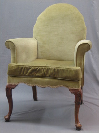 A  Queen Anne style walnut framed armchair, upholstered in green material and raised on cabriole supports