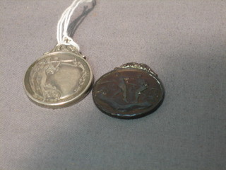A silver boxing medallion and a bronze boxing medallion