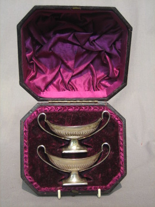 A pair of silver twin handles salts with demi-reeded decoration raised on square feet, Sheffield 1911, 2 ozs