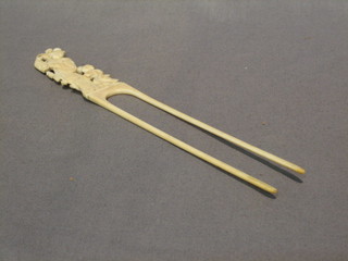 A 19th Century Oriental carved ivory twin pronged hair slide 9"