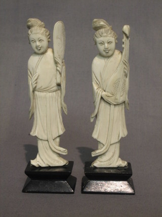 A pair of carved ivory figures of standing attendants 5"