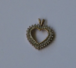 A 9ct gold heart shaped pendant set numerous diamonds