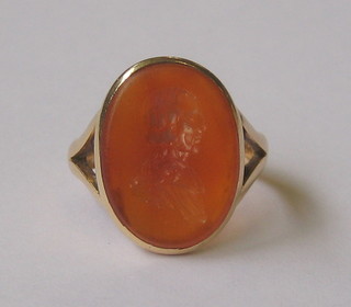 An 18ct gold dress ring set an intaglio cut "cornelian" in the form of a gentleman