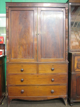 A 19th Century mahogany linen press, the converted interior fitted hanging rails, the base fitted 2 dummy drawers above 1 long dummy drawer and 1 drawer, raised on bracket feet 42"