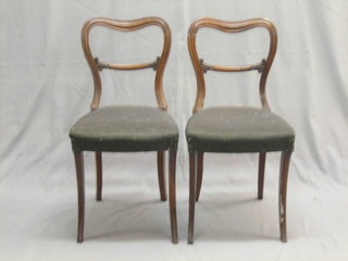 A set of 6 Victorian rosewood spoon back dining chairs with shaped mid rails, raised on sabre supports