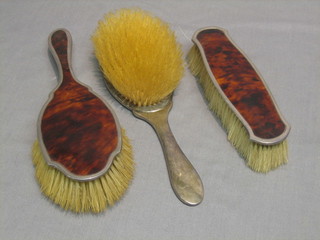 A pair of silver and tortoiseshell backed hair brushes, Birmingham 1902 and 1927 and matching clothes brush