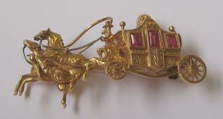 An 18ct gold brooch in the form of a coach and two
