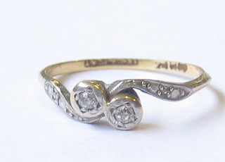 A lady's 18ct gold cross-over dress ring set 2 diamonds