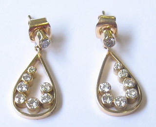 A pair of modern 18ct gold hoop shaped earrings set 8 brilliant cut diamonds