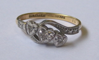 An 18ct 3 stone cross-over illusion diamond set dress ring