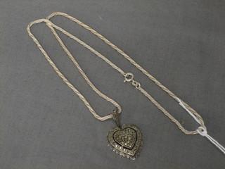 A marcasite heart shaped pendant hung on a silver chain
