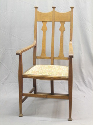 An Art Nouveau oak high back carver chair