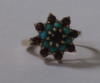 A gold dress ring set garnets and turquoise