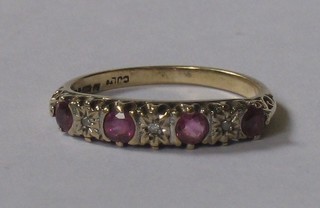 A lady's gold half eternity ring set rubies and diamonds