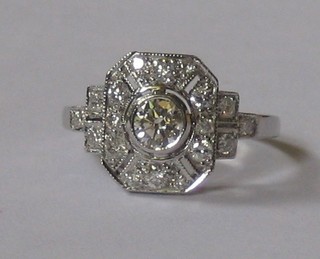 A lady's 18ct white gold dress ring set a diamond surrounded by numerous diamonds