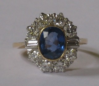 A lady's 18ct yellow gold dress ring set an oval cut sapphire supported by 2 baguette cut diamonds and 10 other small diamonds, approx 1.25/1.70ct