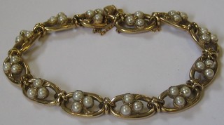 A lady's pierced gold bracelet set pearls