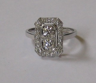A lady's 18ct white gold dress ring with rectangular pierced setting, set numerous diamonds, approx 0.85ct