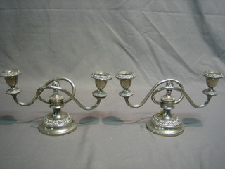 A pair of modern silver plated twin light candelabrum