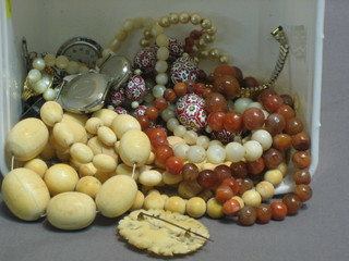 2 strings of ivory beads, an ivory teething bar, 2 pierced ivory brooches, various beads, wristwatches etc
