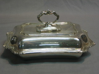 A shaped silver plated entree dish and cover