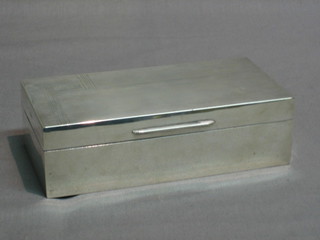 A rectangular silver cigarette box with hinged lid, Birmingham 1934 7"