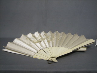A 19th Century ivory fan with embroidered silk panels (1 guard f) contained in a silk box