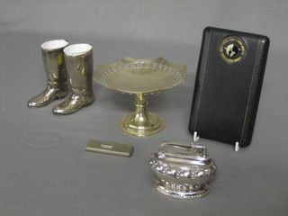 A cigarette case with timer, a Ronson silver plated Queen Anne style table lighter, a pair of match strikers in the form of riding boots, a cigar cutter and a small silver plated comport