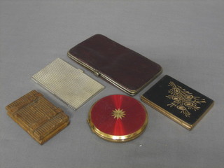 A silver plated card case, a leather covered cigarette case, a small wooden stamp box and 2 compacts