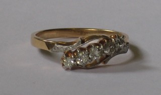 A lady's 18ct gold dress ring set 5 diamonds supported by diamonds