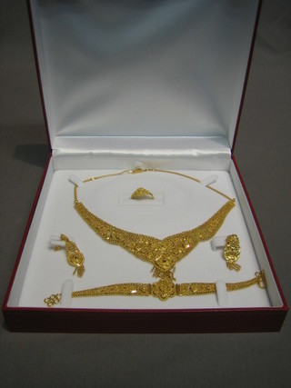 A suite of Oman pierced 22ct gold jewellery comprising necklace, ring, pair of earrings and bracelet (the gift of a member of the Oman Royal family) approx 60g