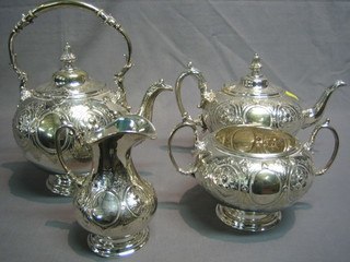 An embossed silver plated 4 piece tea service comprising tea kettle, teapot, twin handled sugar bowl and cream jug