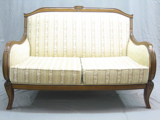 A modern Continental walnut show frame 2 seat settee upholstered in striped material, raised on cabriole supports 55" 