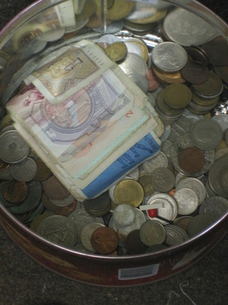 A collection of paper money and foreign coins