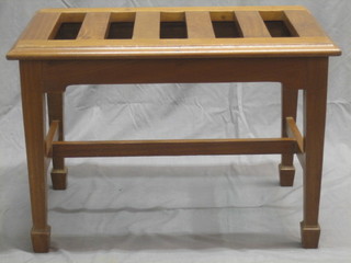 An Edwardian slatted mahogany luggage rack with H framed stretcher, raised on square supports ending in spade feet 26"