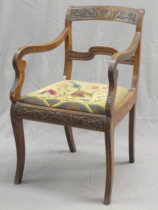 A Victorian carved fruitwood? open arm bar back carver chair with shaped mid rail and upholstered drop in seat, raised on front and rear sabre supports