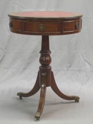A Georgian style drum table with inset leather surface, fitted drawers, raised on pillar and tripod supports 20"