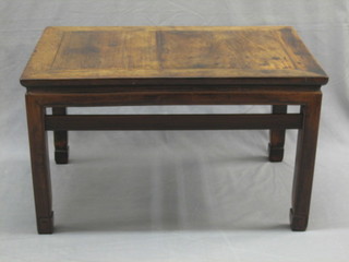 A rectangular Padouk wood table, raised on square supports 30"