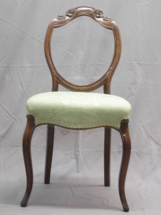 A Victorian mahogany balloon back dining chair with shaped mid rails, seat of serpentine outline, raised on cabriole supports