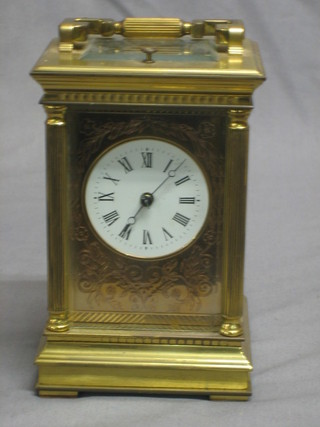 A 20th Century English 8 day repeating carriage clock contained in a gilt metal case