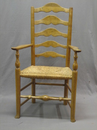 A light elm ladder back carver chair with woven rush seat
