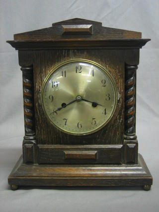 An Edwardian 8 day striking bracket clock with silvered dial and Arabic numerals contained in an oak case